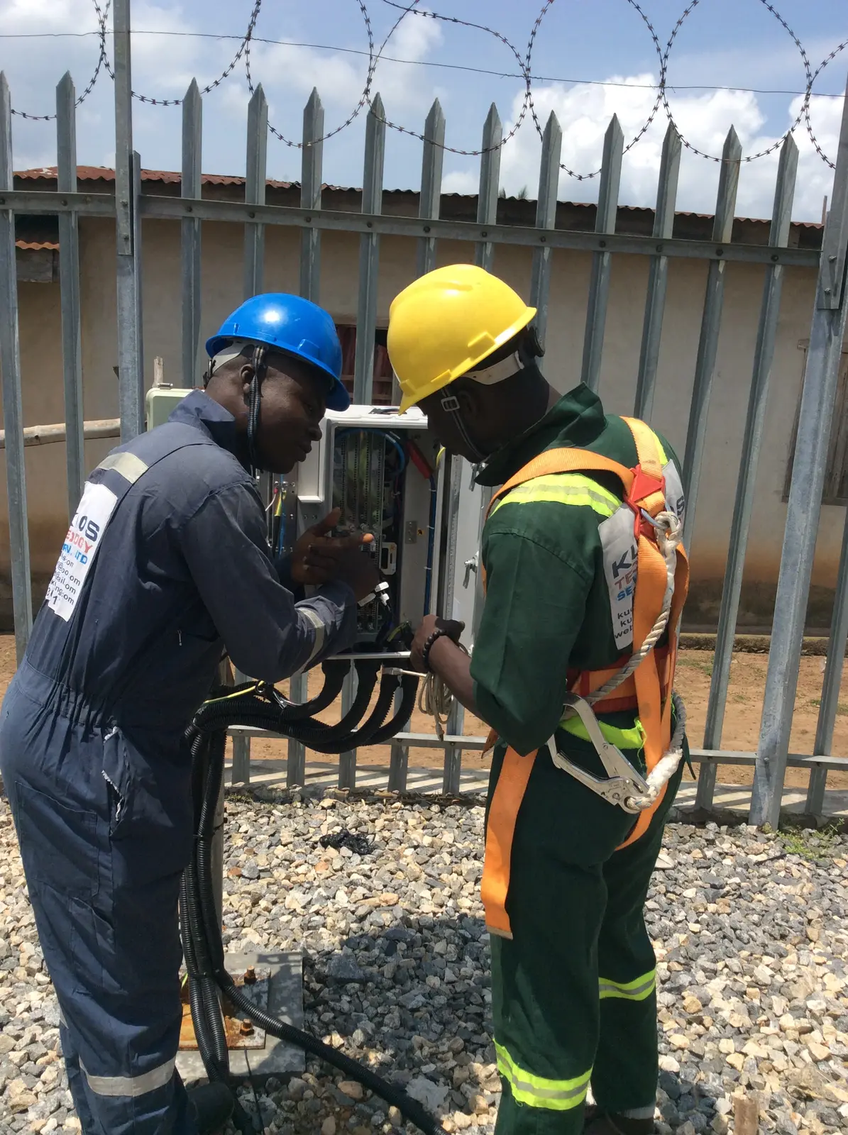 Field engineers connecting telecommunications cables at an outdoor site
