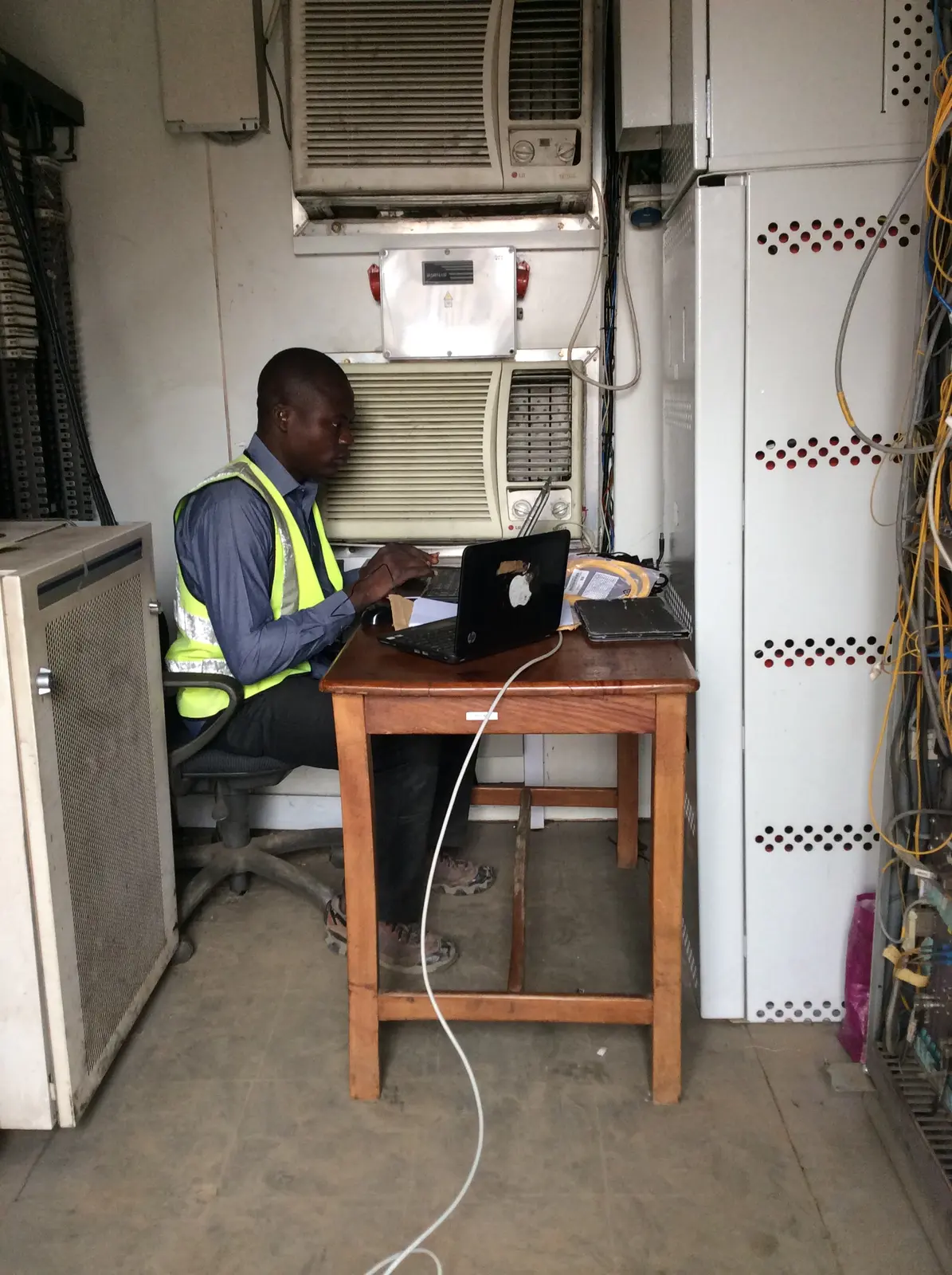 Kudos engineer testing network equipment with a laptop