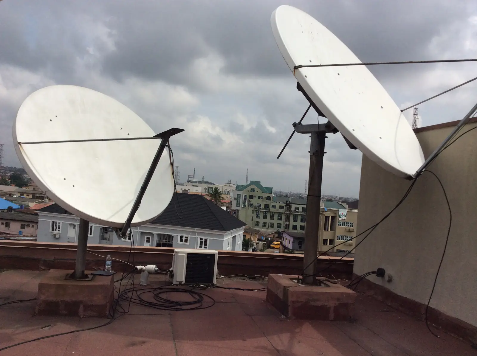 Multiple satellite dishes installed on a rooftop communications site