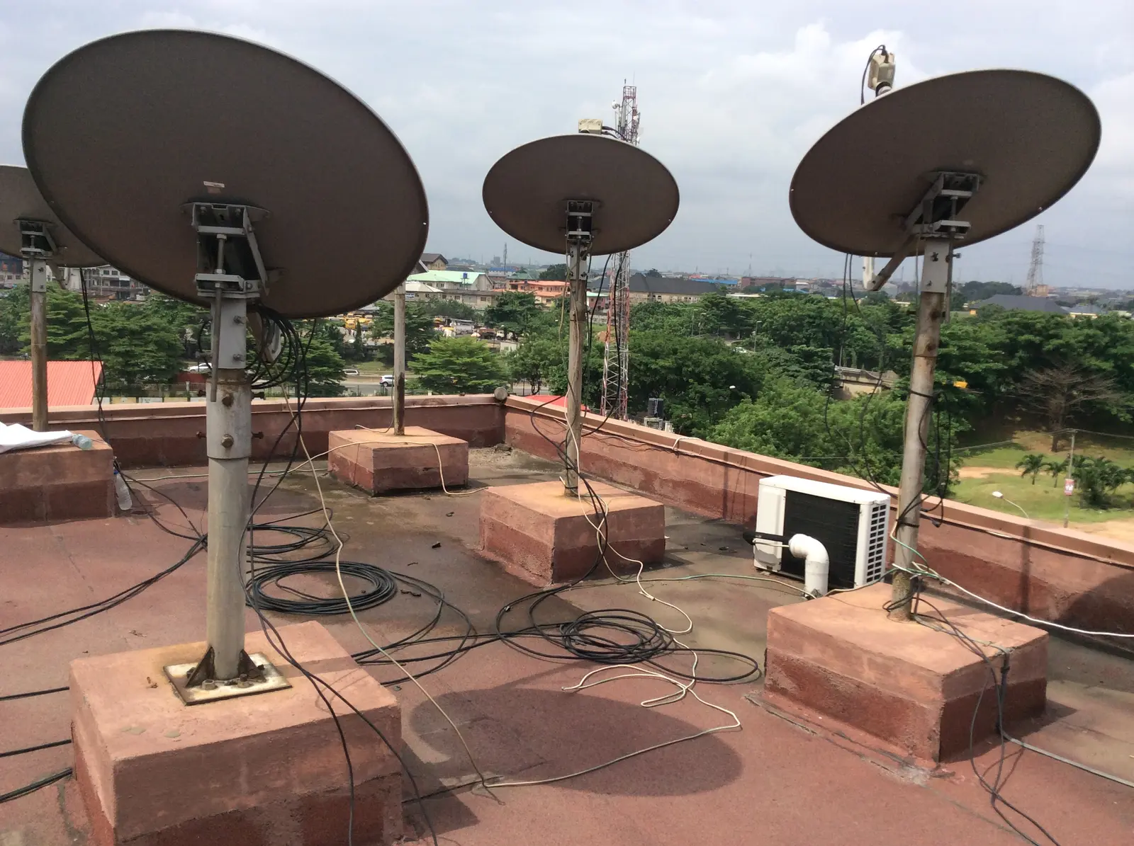 Array of satellite communication dishes at a rooftop site