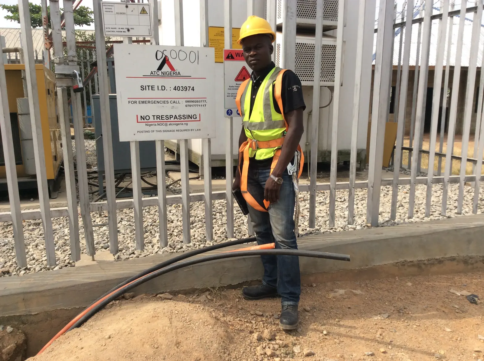 Field engineer at the entrance of a telecommunications site