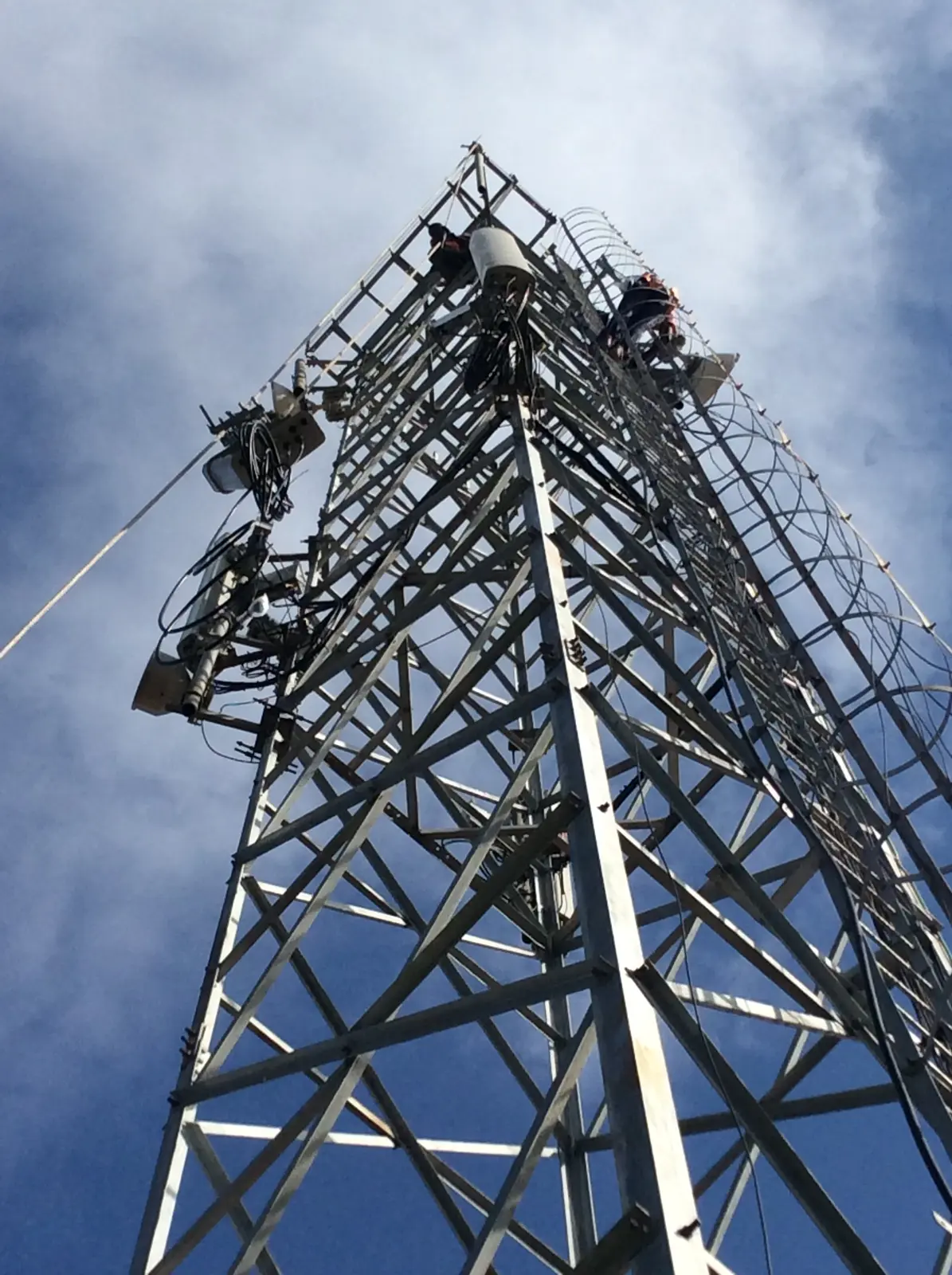 Upward view of antenna systems installed on a telecommunications tower